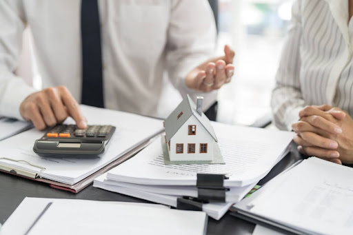 Couple doing calculations regarding their home insurance.